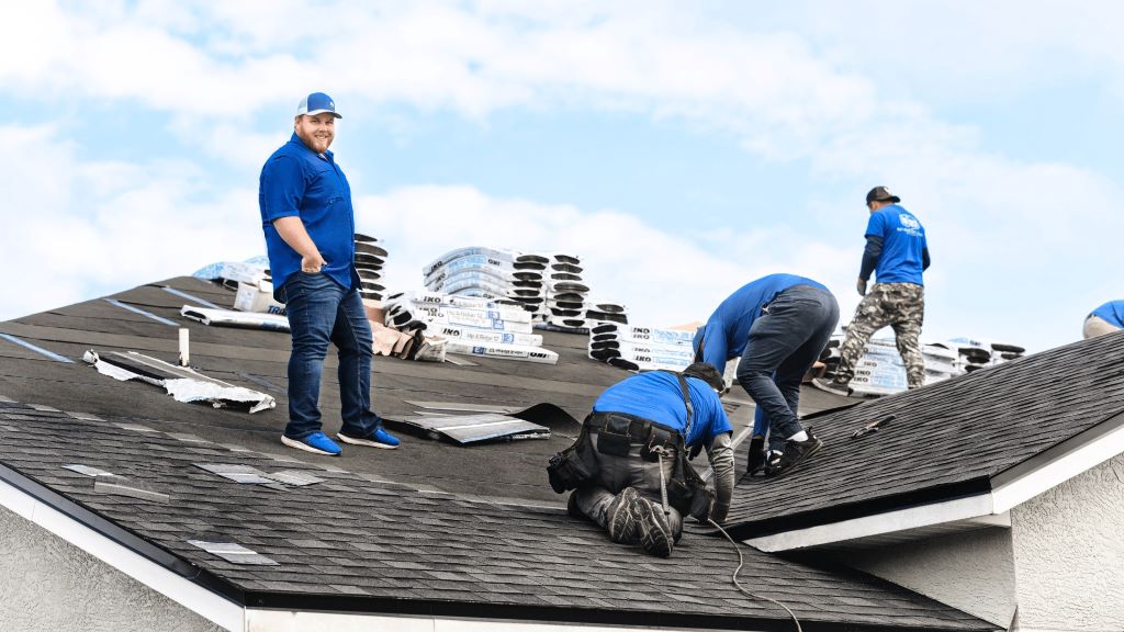Professional roofing team fixing a Florida roof to prevent leaks and withstand severe weather