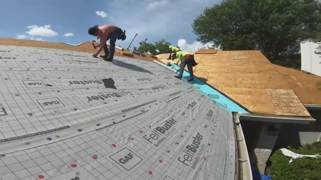 Storm clouds looming over Texas rooftops, highlighting risks to home roofs